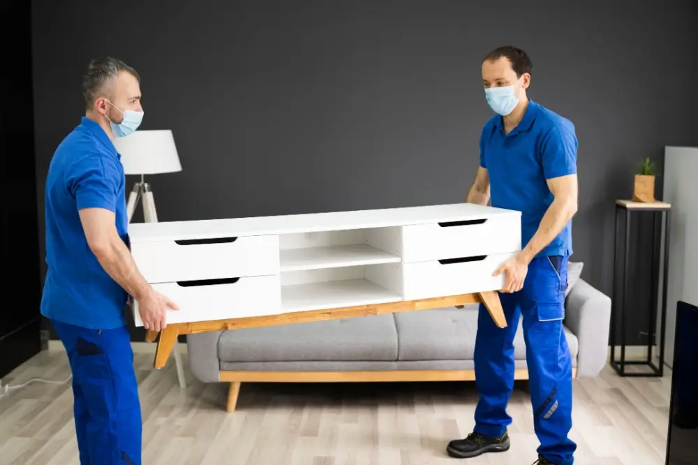 a team of packers and movers in jp nagar moving a tv table.